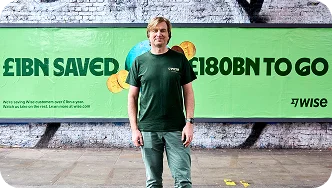 Wise CEO Kristo standing in front of a billboard