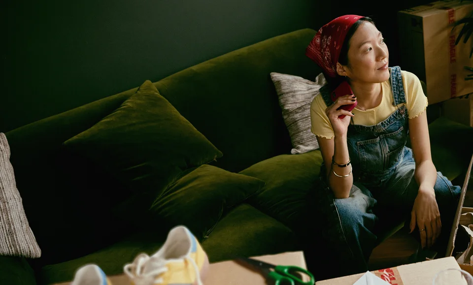 Woman sitting on a green sofa