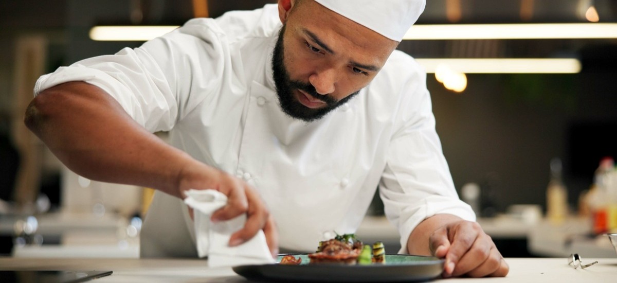 close up of chef plating food