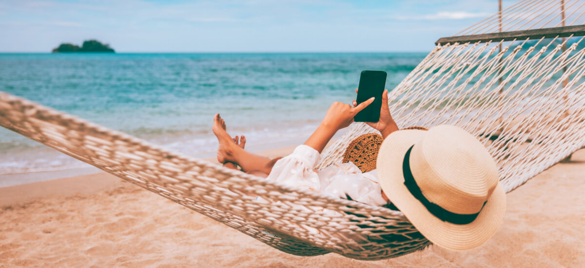 tourist-using-phone-in-hammock