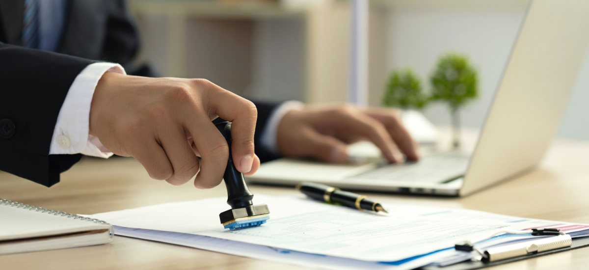 bank-employee-stamping-documents