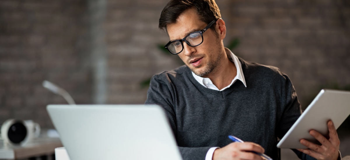 man-calculating-figures-using-laptop
