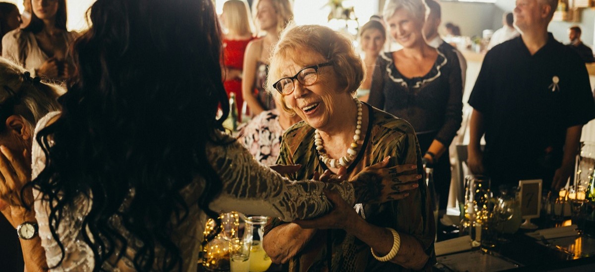 Older woman smling at a cafe bar