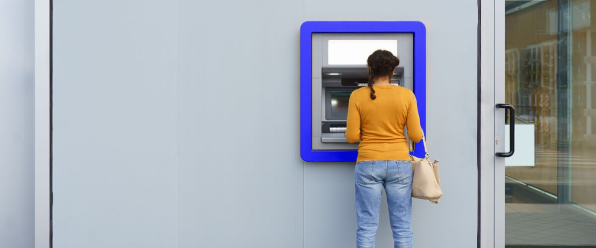 Eine Frau an einem Bancomaten