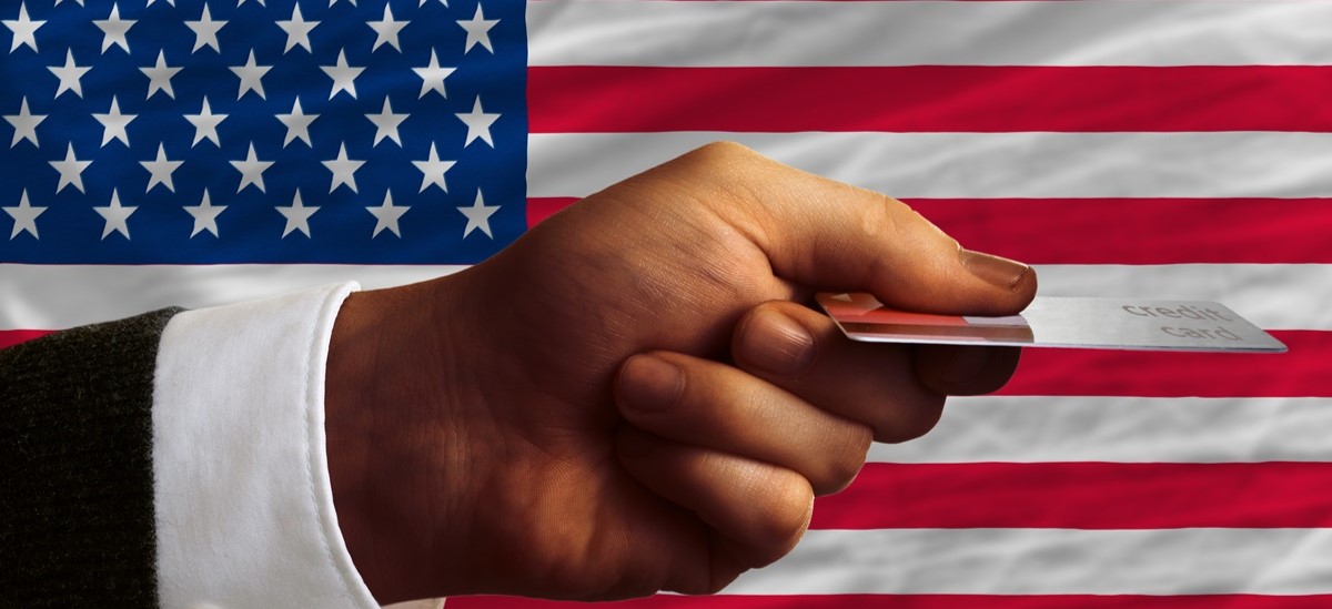 Card being held in front of a US flag