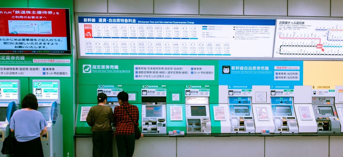 Commuters purchasing tickets and IC cards at Japanese train station