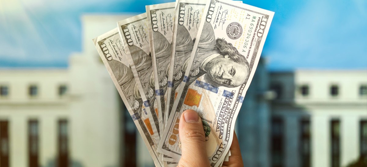 US dollars being held up in front of US government building