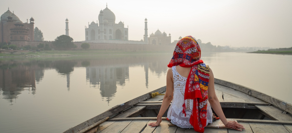 woman-sitting-on-boat-overlooking-taj-mahal-india