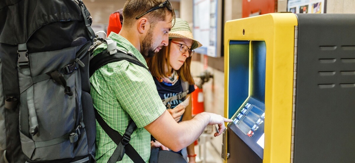 tourists-with-backpack-withdrawing-cash-atm