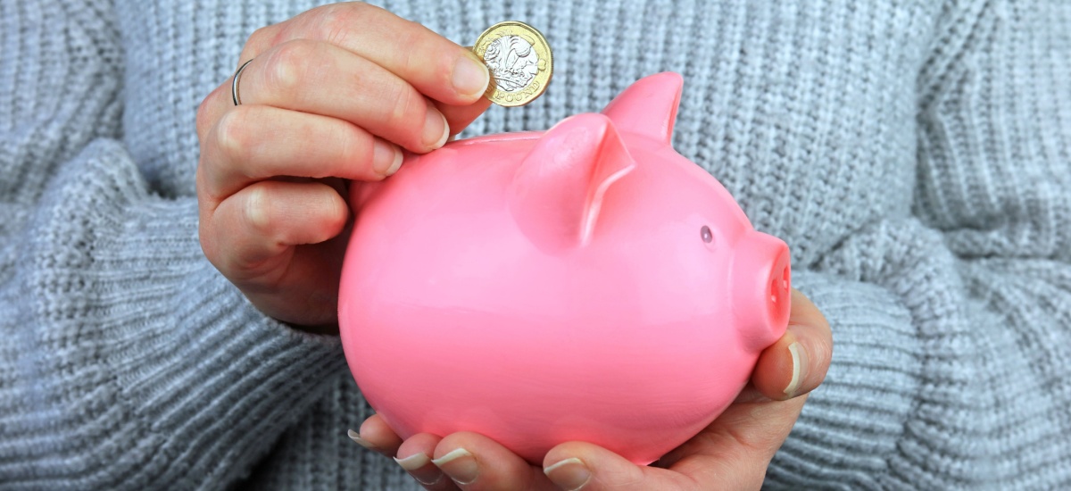 woman-putting-coins-into-savings