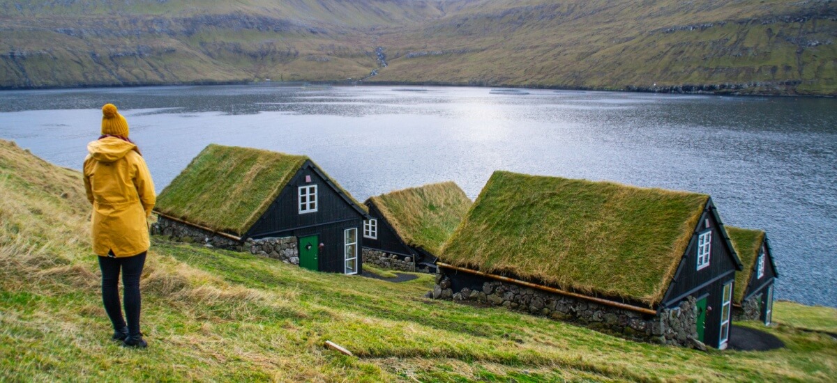 woman-looking-at-danish-summer-houses-by-lake