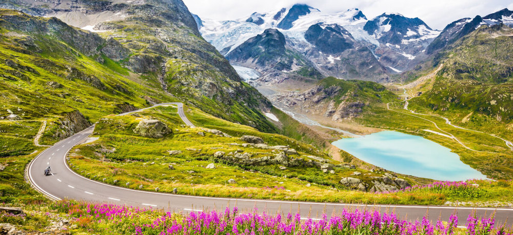 motorcyclist-driving-on-winding-road-in-alps