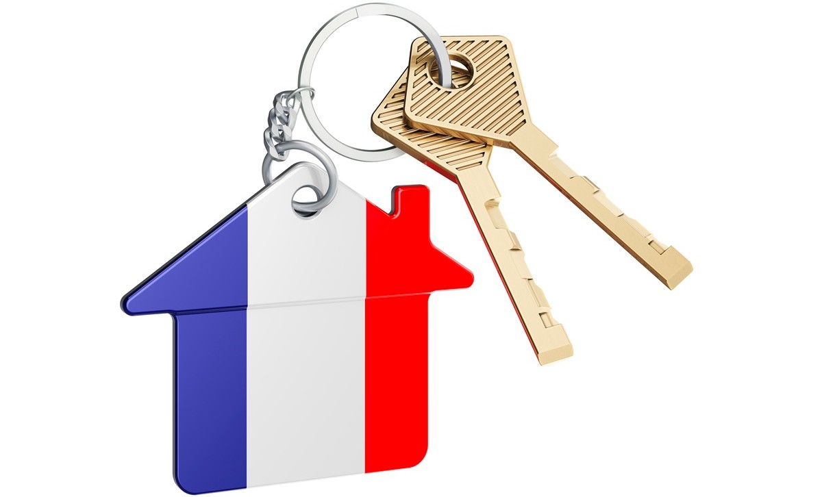 keys with a keyring attached shaped like a house with the French flag on it