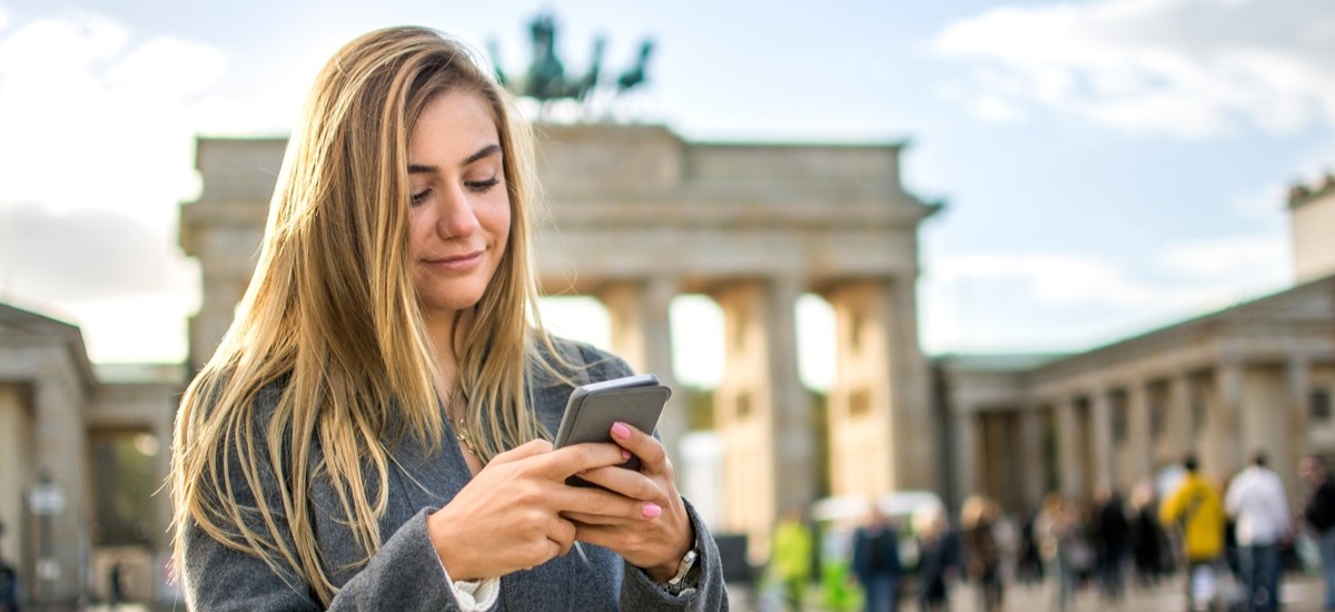 woman in Berlin, looking at a mobile phone