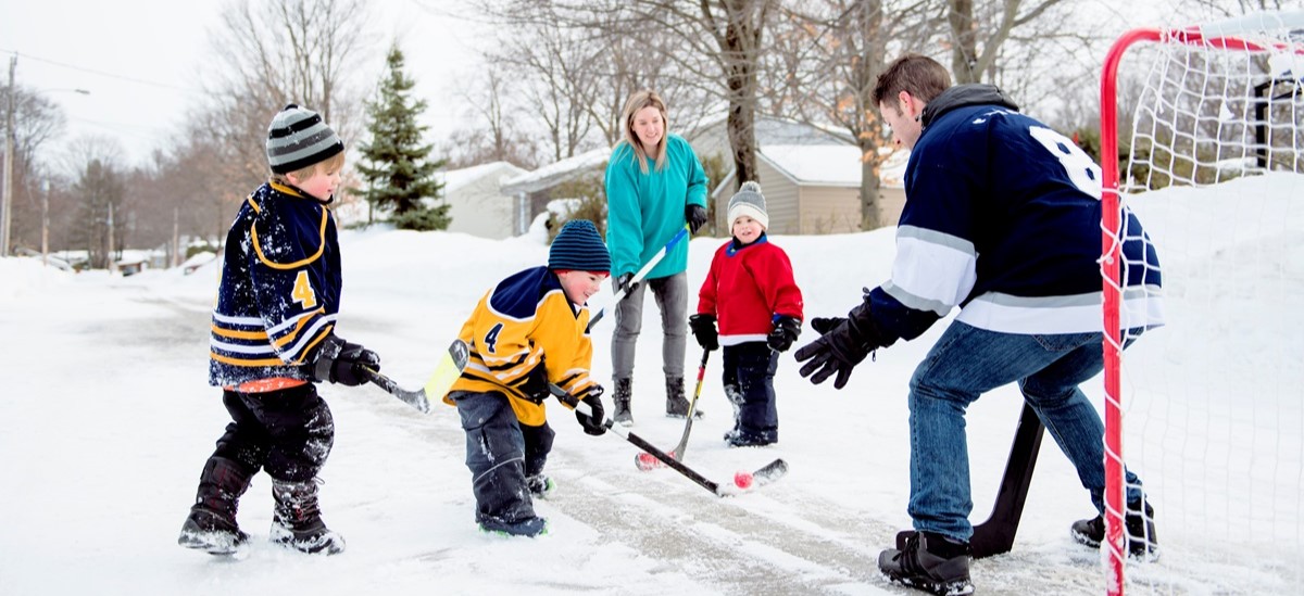 family playing ice hockey in Canada