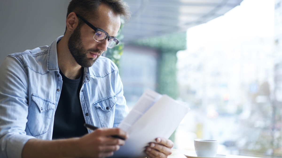man-analysing-documents
