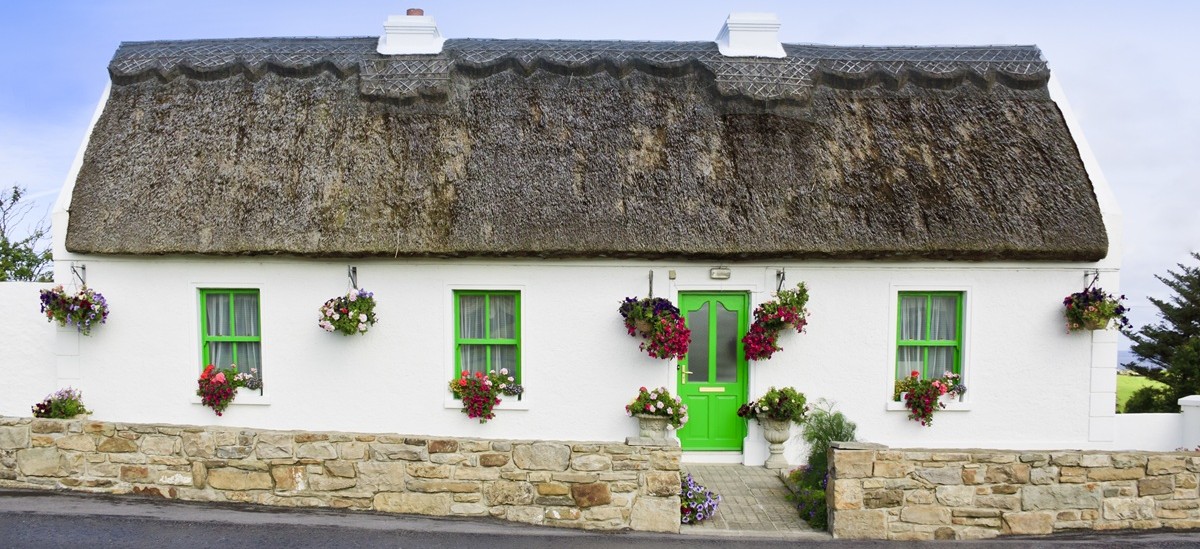 irish style cottage with a thatched roof
