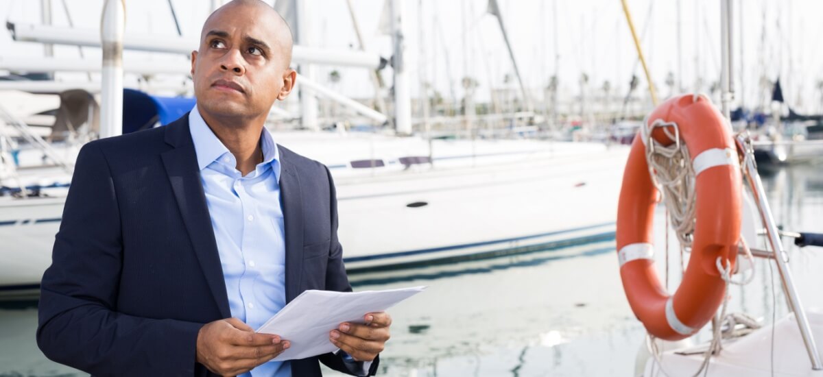man-looking-at-yachts-deciding-to-buy