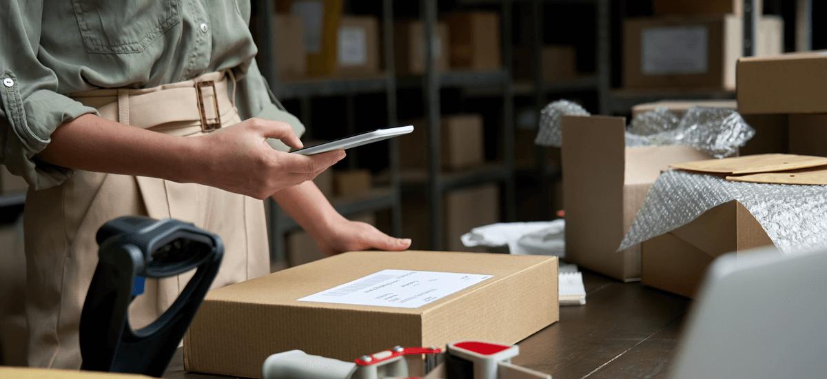 business-woman-barcode-scanning-inventory-with-phone