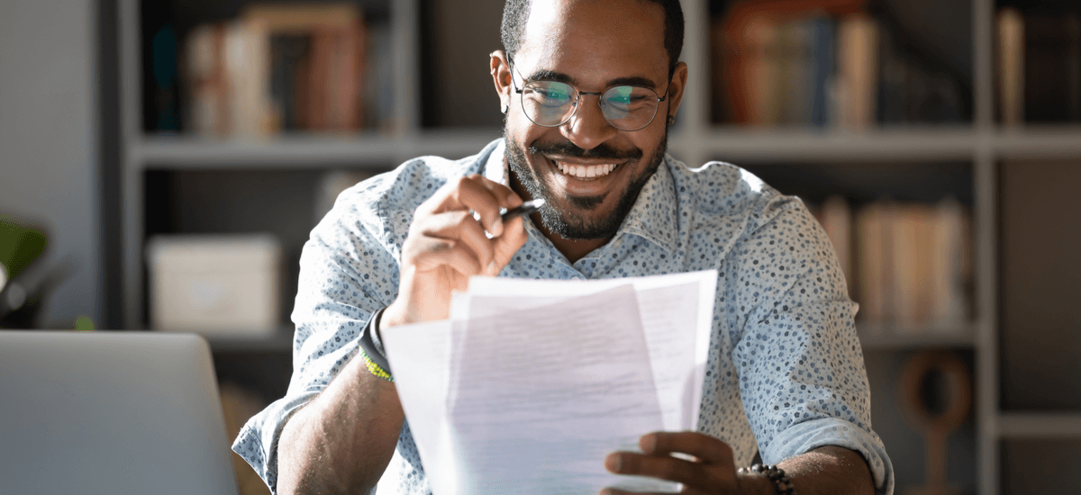 (happy-man-learning-studying-paper)