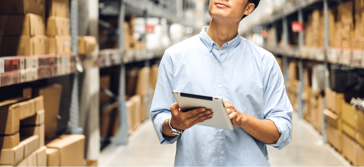 business-man-with-tablet-in-large-depot