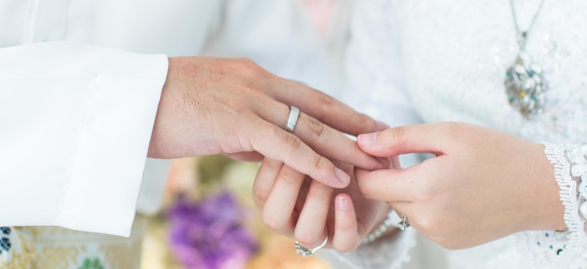 Closeup photo of bride's and groom's hands