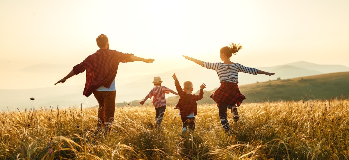 family-running-towards-sunset